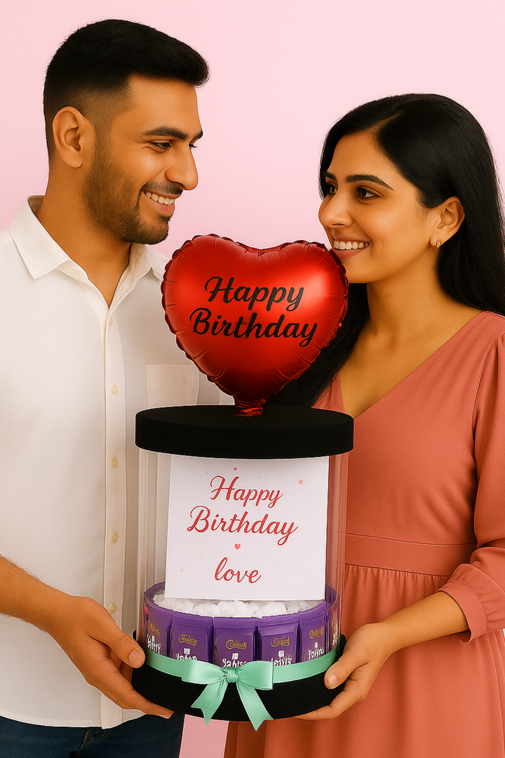 Couple Holding Birthday Gift Hamper with Heart Balloon and Chocolates – Romantic Surprise Box